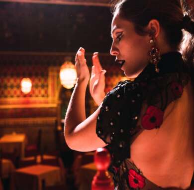 Woman clapping hands and dancing on scene